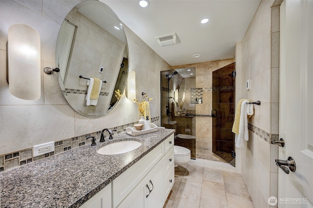 524 Maple St Unit 105, Edmonds, WA 98020 - full bath with tile walls, a shower stall, vanity, and recessed lighting