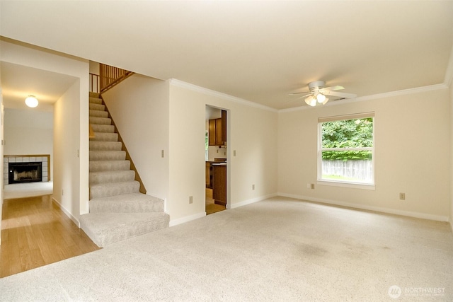 14626 58th Dr SE, Everett, WA 98208 - unfurnished living room with a tile fireplace, a ceiling fan, carpet floors, and crown molding