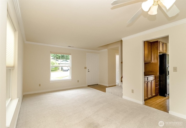 14626 58th Dr SE, Everett, WA 98208 - unfurnished living room with light colored carpet, crown molding, and ceiling fan
