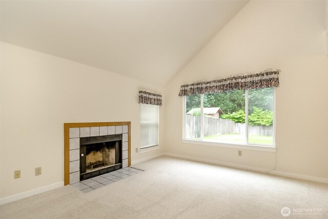 14626 58th Dr SE, Everett, WA 98208 - unfurnished living room with carpet, a tiled fireplace, and high vaulted ceiling
