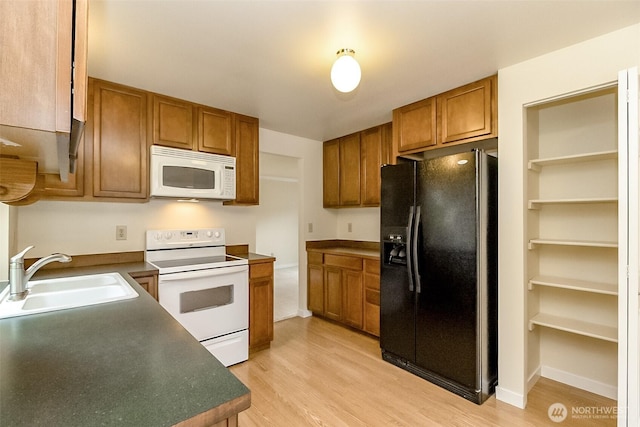 14626 58th Dr SE, Everett, WA 98208 - kitchen featuring white appliances, brown cabinetry, light wood finished floors, and dark countertops