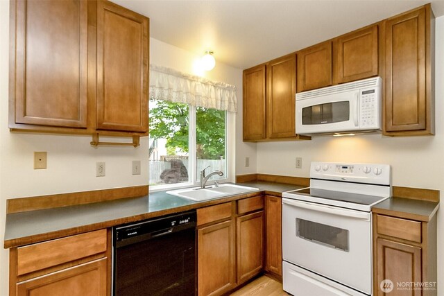 14626 58th Dr SE, Everett, WA 98208 - kitchen featuring white appliances, brown cabinetry, dark countertops, and light wood-type flooring