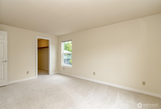 14626 58th Dr SE, Everett, WA 98208 - unfurnished bedroom featuring light carpet and a walk in closet