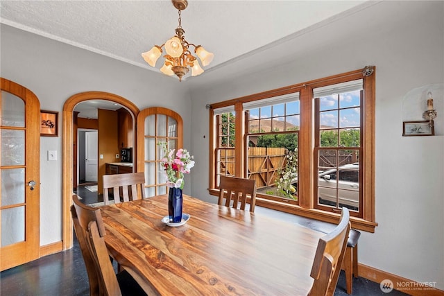 2020 Easy St, Wenatchee, WA 98801 - dining space with a chandelier, arched walkways, and a textured ceiling