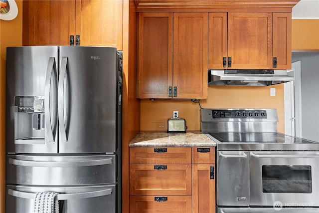 2020 Easy St, Wenatchee, WA 98801 - kitchen featuring appliances with stainless steel finishes, under cabinet range hood, brown cabinetry, and light stone countertops