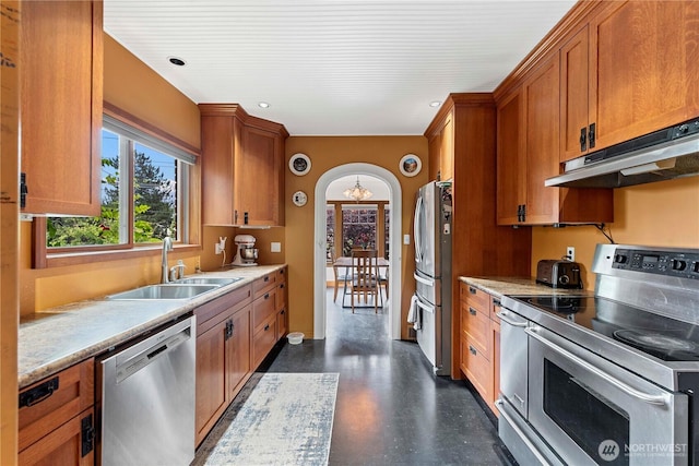 2020 Easy St, Wenatchee, WA 98801 - kitchen featuring appliances with stainless steel finishes, a chandelier, under cabinet range hood, brown cabinets, and light countertops