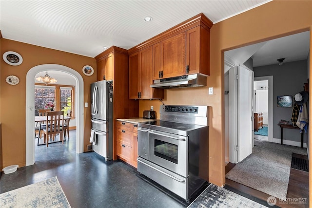 2020 Easy St, Wenatchee, WA 98801 - kitchen featuring stainless steel appliances, under cabinet range hood, arched walkways, brown cabinetry, and light countertops