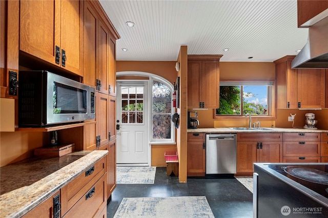 2020 Easy St, Wenatchee, WA 98801 - kitchen featuring stainless steel appliances, brown cabinetry, finished concrete flooring, wall chimney range hood, and recessed lighting