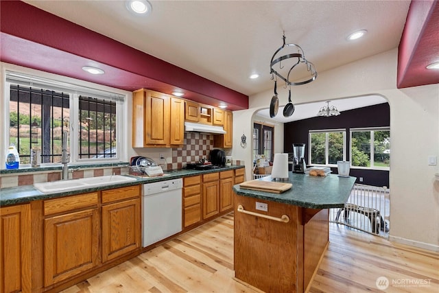 2020 Easy St, Wenatchee, WA 98801 - kitchen with white dishwasher, arched walkways, under cabinet range hood, light wood-type flooring, and recessed lighting