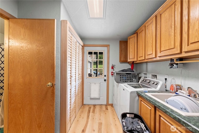 2020 Easy St, Wenatchee, WA 98801 - washroom with separate washer and dryer, cabinet space, light wood-type flooring, and a textured ceiling