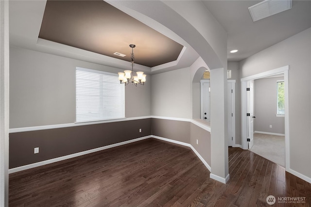 535 Beechwood Ct SW, Olympia, WA 98502 - empty room with a tray ceiling, dark wood-style floors, a chandelier, arched walkways, and recessed lighting