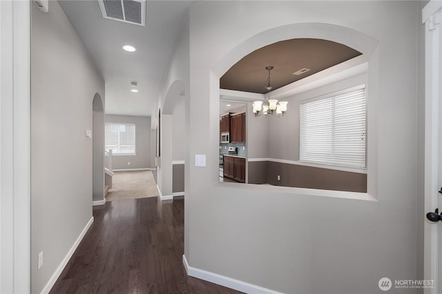 535 Beechwood Ct SW, Olympia, WA 98502 - hall featuring arched walkways, dark wood-style floors, a chandelier, and recessed lighting