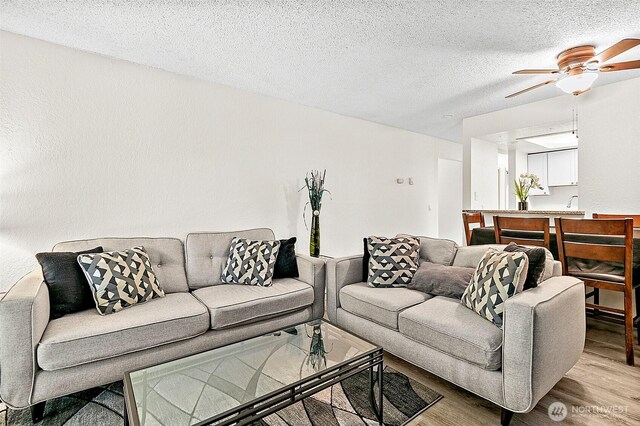 33011 18th Pl S Unit F205, Federal Way, WA 98003 - living room featuring wood finished floors, ceiling fan, and a textured ceiling