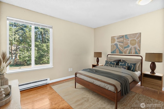 33011 18th Pl S Unit F205, Federal Way, WA 98003 - bedroom with a baseboard radiator and wood finished floors