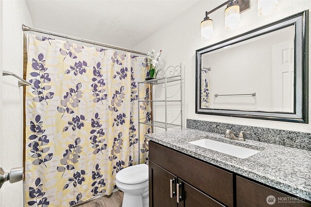 33011 18th Pl S Unit F205, Federal Way, WA 98003 - bathroom featuring vanity, wood finished floors, and a shower with shower curtain