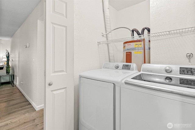 33011 18th Pl S Unit F205, Federal Way, WA 98003 - washroom featuring washing machine and dryer, a textured wall, and light wood-style floors