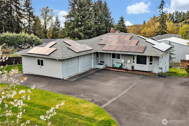 11022 SE 313th St, Auburn, WA 98092 - mid-century modern home featuring roof with shingles, roof mounted solar panels, asphalt driveway, a chimney, and a garage
