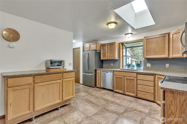11022 SE 313th St, Auburn, WA 98092 - kitchen with stainless steel appliances, a skylight, and light brown cabinetry