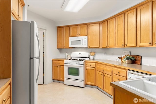 8500 Main St Unit F205, Edmonds, WA 98026 - kitchen with white appliances, light flooring, and light countertops