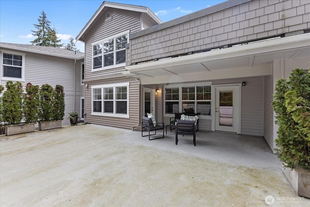 8500 Main St Unit F205, Edmonds, WA 98026 - rear view of house featuring a patio and an outdoor hangout area