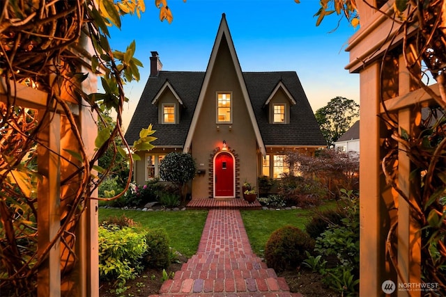 251 N Garden St, Bellingham, WA 98225 - tudor-style house with a shingled roof, a chimney, a front lawn, and stucco siding