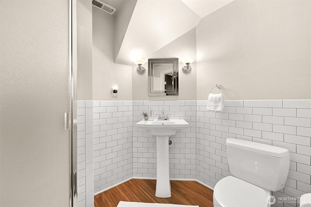 251 N Garden St, Bellingham, WA 98225 - bathroom featuring tile walls, wainscoting, wood finished floors, and an enclosed shower