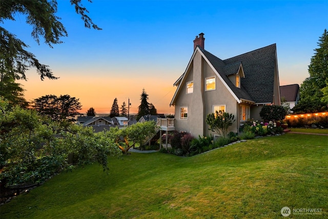 251 N Garden St, Bellingham, WA 98225 - view of side of home featuring stucco siding, a lawn, and a chimney