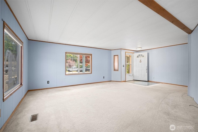 8265 Skeena Way, Blaine, WA 98230 - empty room featuring carpet floors, healthy amount of natural light, crown molding, and wood walls