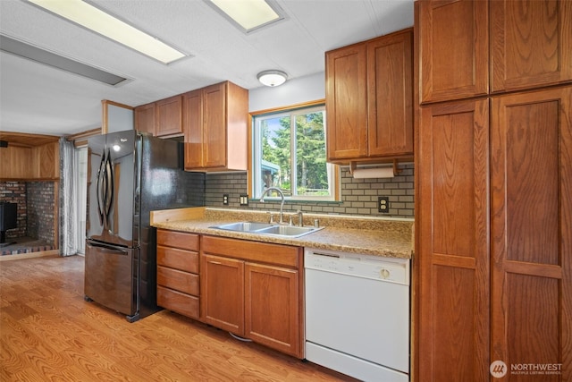 8265 Skeena Way, Blaine, WA 98230 - kitchen with dishwasher, light wood-style flooring, brown cabinetry, and freestanding refrigerator