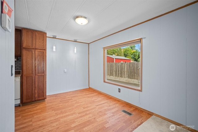 8265 Skeena Way, Blaine, WA 98230 - spare room with light wood-type flooring, crown molding, and a decorative wall