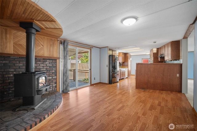 8265 Skeena Way, Blaine, WA 98230 - living area featuring a wood stove and light wood-style flooring