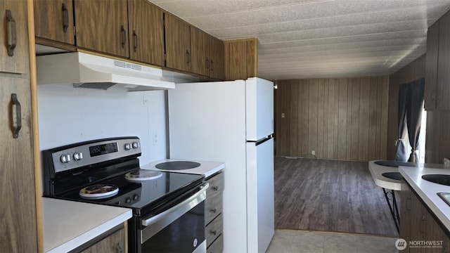 511 Leisure Cir, Aberdeen, WA 98520 - kitchen featuring stainless steel range with electric stovetop, under cabinet range hood, light countertops, and wood walls