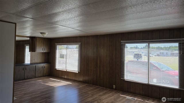 511 Leisure Cir, Aberdeen, WA 98520 - unfurnished dining area featuring dark wood finished floors and wooden walls