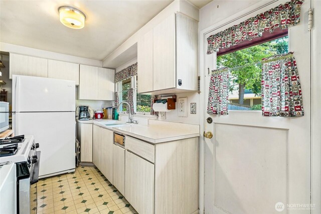 10629 NE 26th St, Bellevue, WA 98004 - kitchen with white appliances, light countertops, plenty of natural light, and light floors