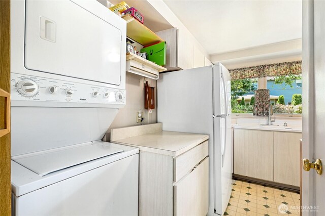 10629 NE 26th St, Bellevue, WA 98004 - laundry area with estacked washer and dryer and light floors