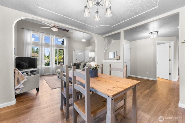 7605 38th Ct SE, Lacey, WA 98503 - dining room with arched walkways, a textured ceiling, ceiling fan, and hardwood / wood-style floors