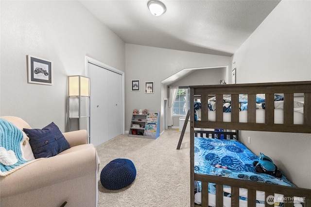 7605 38th Ct SE, Lacey, WA 98503 - bedroom featuring carpet floors, vaulted ceiling, and a closet