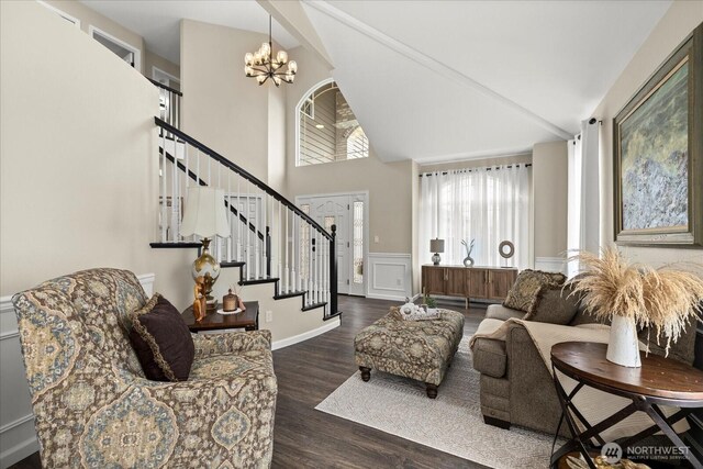 4212 145th Pl SE, Snohomish, WA 98296 - living area with high vaulted ceiling, stairway, wood finished floors, a chandelier, and wainscoting