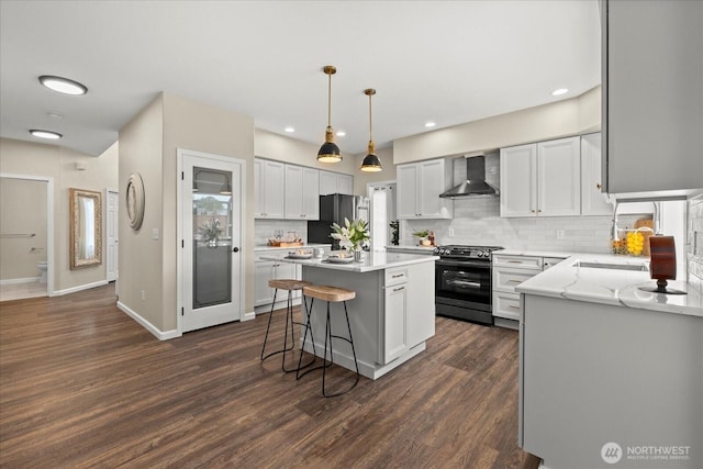 4212 145th Pl SE, Snohomish, WA 98296 - kitchen with stainless steel appliances, wall chimney exhaust hood, a center island, tasteful backsplash, and dark wood finished floors