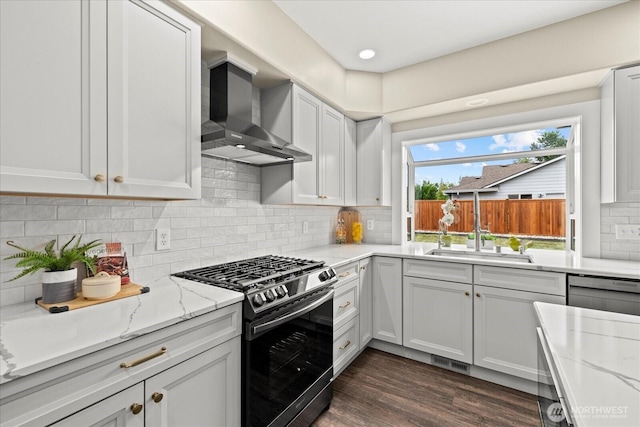 4212 145th Pl SE, Snohomish, WA 98296 - kitchen featuring stainless steel range with gas cooktop, wall chimney range hood, light stone countertops, and tasteful backsplash