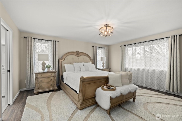 4212 145th Pl SE, Snohomish, WA 98296 - bedroom featuring multiple windows, light wood-type flooring, and a chandelier