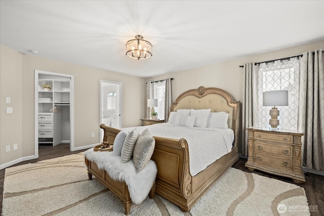 4212 145th Pl SE, Snohomish, WA 98296 - bedroom with a chandelier, a walk in closet, wood finished floors, and ensuite bath