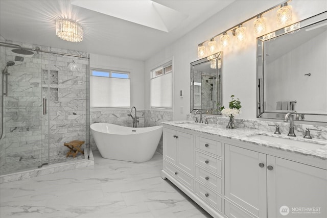 4212 145th Pl SE, Snohomish, WA 98296 - bathroom featuring a shower stall, a freestanding tub, marble finish floors, double vanity, and a skylight
