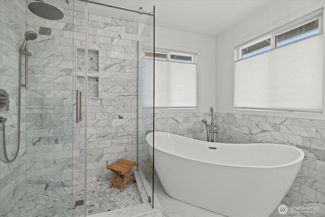 4212 145th Pl SE, Snohomish, WA 98296 - bathroom featuring marble look tiles, a stall shower, a freestanding bath, and tile walls