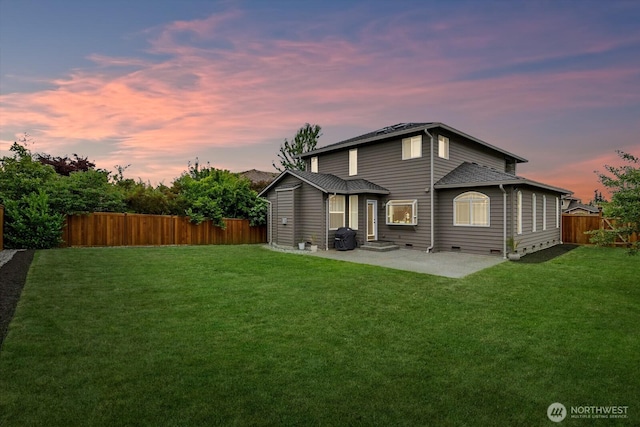 4212 145th Pl SE, Snohomish, WA 98296 - back of property at dusk with a patio area and a fenced backyard