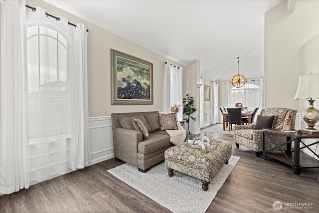 4212 145th Pl SE, Snohomish, WA 98296 - living room with dark wood finished floors, a chandelier, a wainscoted wall, and lofted ceiling
