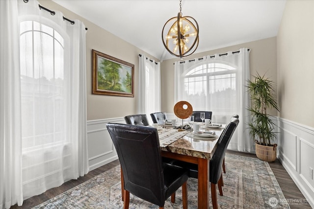 4212 145th Pl SE, Snohomish, WA 98296 - dining space with a chandelier, a wainscoted wall, dark wood-type flooring, lofted ceiling, and a decorative wall