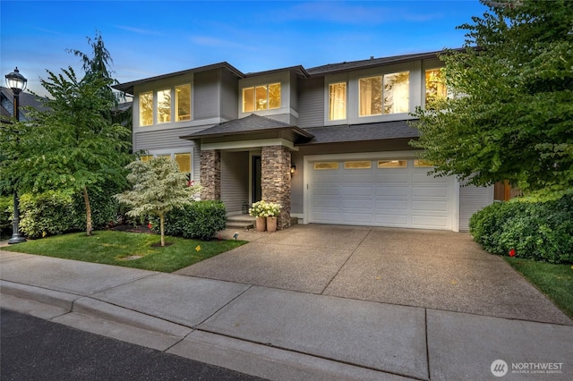 619 Graham Ave NE, Renton, WA 98059 - view of front of property featuring an attached garage, concrete driveway, stone siding, and a front lawn