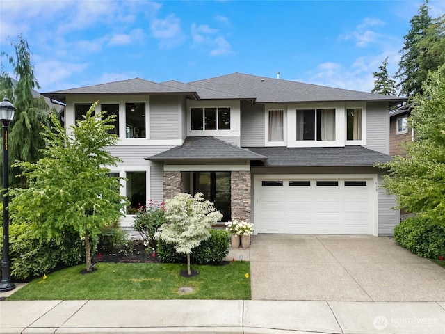 619 Graham Ave NE, Renton, WA 98059 - prairie-style home featuring concrete driveway, an attached garage, a front lawn, stone siding, and a shingled roof