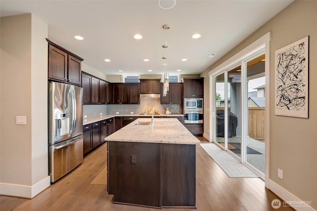 619 Graham Ave NE, Renton, WA 98059 - kitchen featuring appliances with stainless steel finishes, dark brown cabinets, light wood-style flooring, decorative backsplash, and recessed lighting